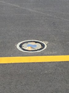 An in-pavement runway edge light, very close to a taxiway center line...